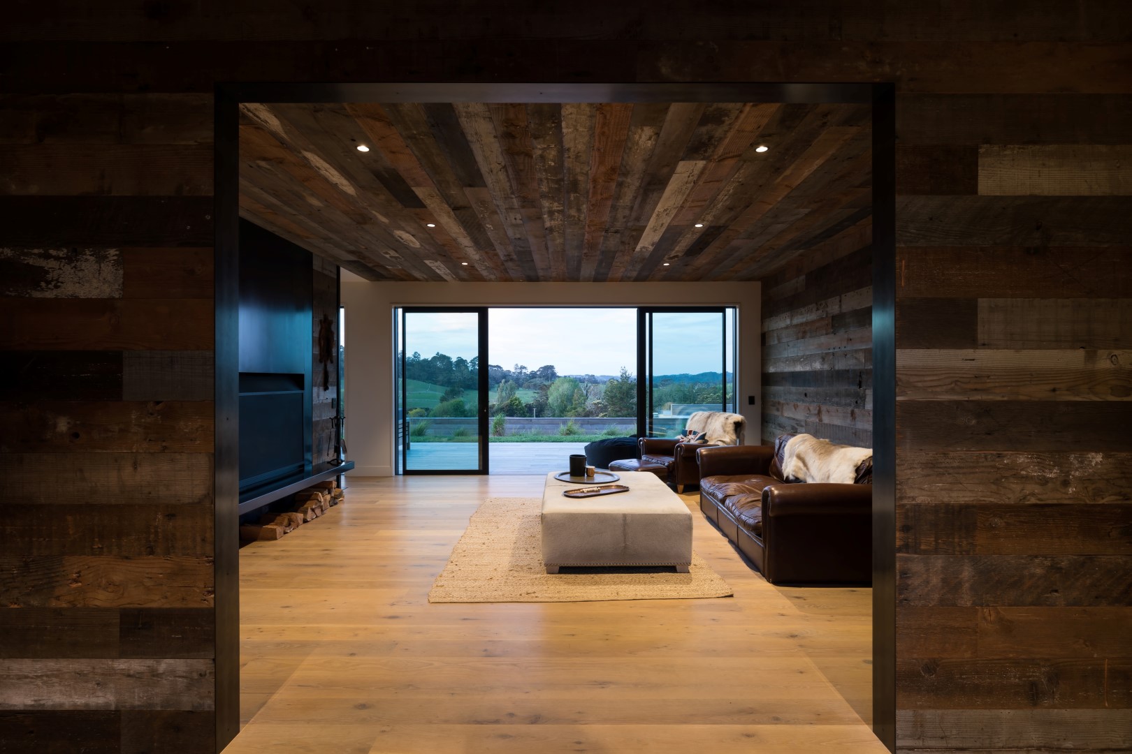 kumeu-residence-arcline-architecture-reclaimed-wood-walls-couches-snug-ceiling