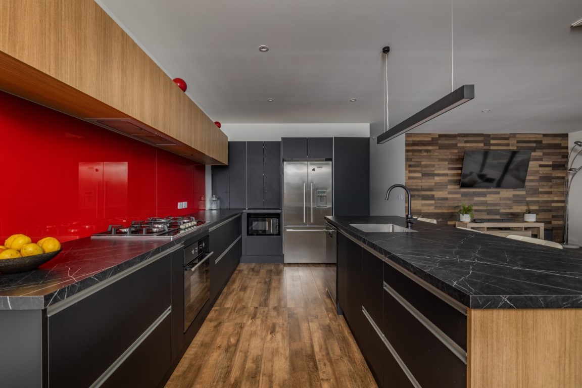 kitchen-dining-living-area-arcline-architecture-timber-floor-red-splashback-carpet