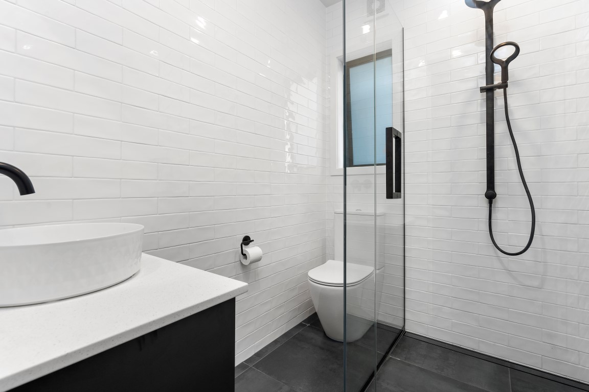 white-black-bathroom-layout-black-vanity-white-toilet-black-ladder-towell-rail-subway-tiles-arcline-architecture