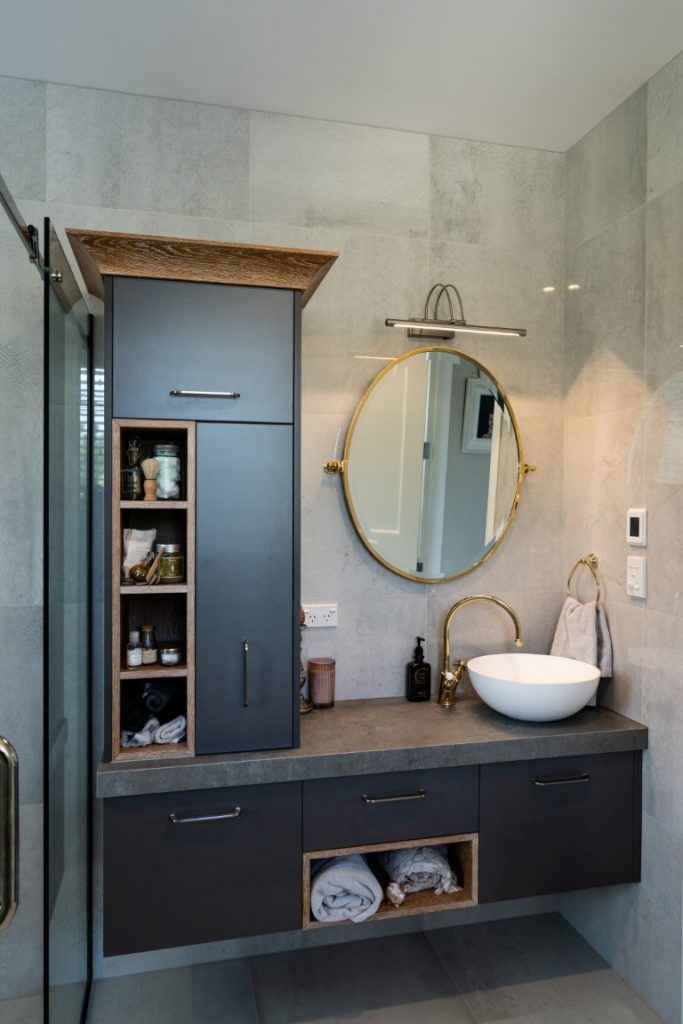 bathroom-vanity-dark-tower-cabinet-oval-mirror-white-basin-timber-feature-drawers-grey-tiles-arcline-architecture