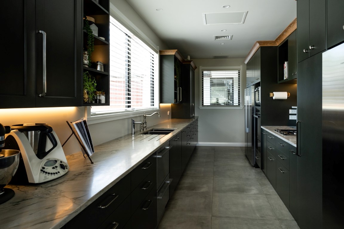 scullery-dark-cabinetry-tiles-stone-bench-sink-pantry-fridge-freezer-cooking-arcline-architecture