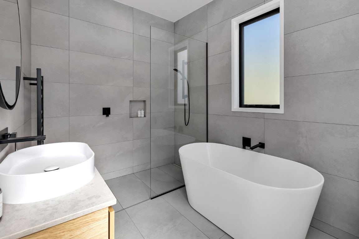 bathroom-design-grey-tiles-timber-vanity-white-bowl-white-bath-ladder-towel-rail-arcline-architecture (3)