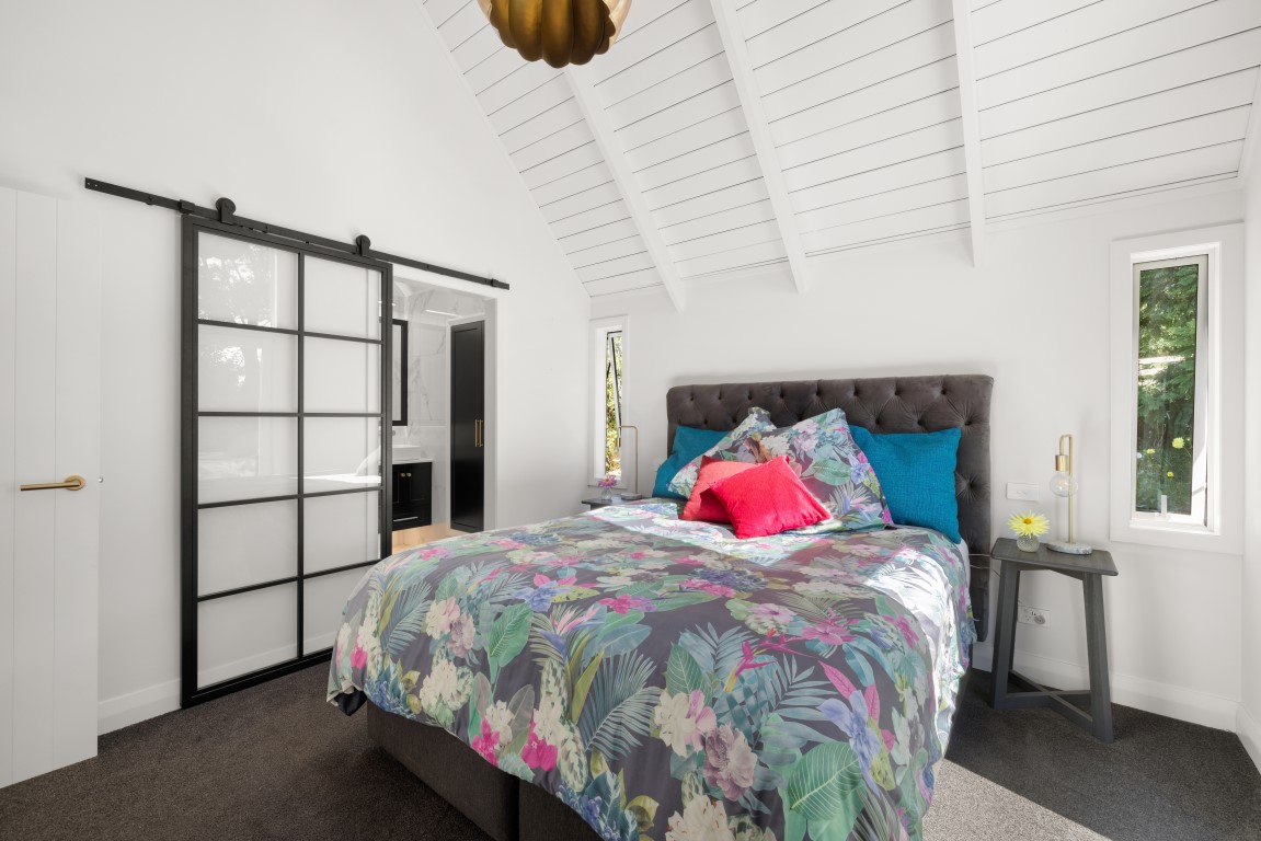 raking-ceiling-white-timber-bedroom-design-interior-layout-arcline-architecture-black-barn-door