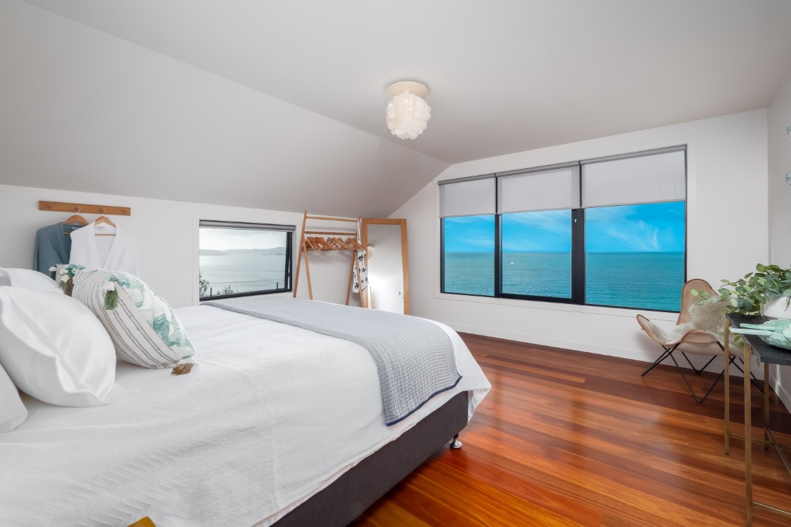 bedroom-with-sea-views-sliding-window-timber-floor-russell-bay-of-islands-arcline-architecture