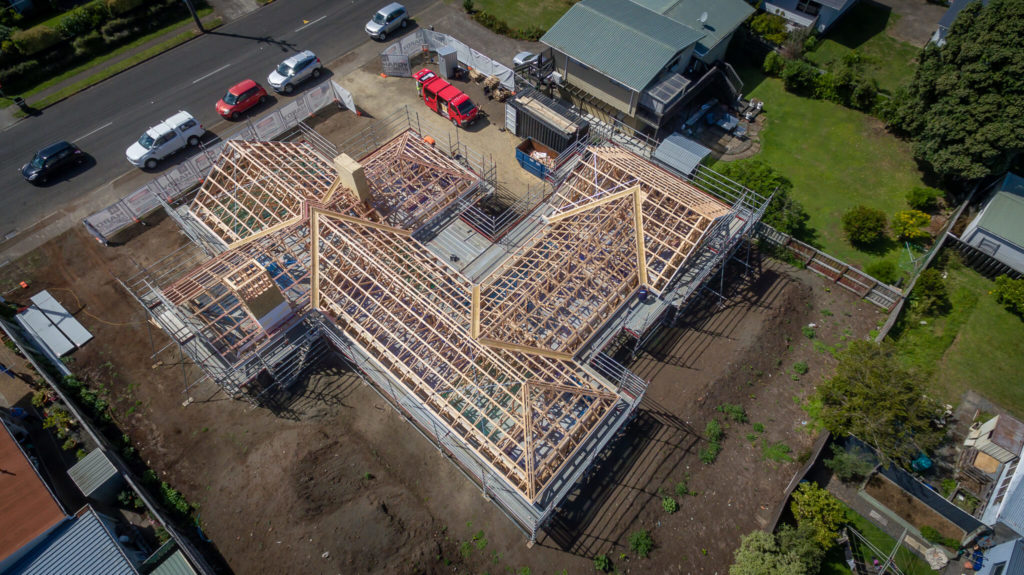 birds-eye-view of a home with framework visible, showing truss roofing