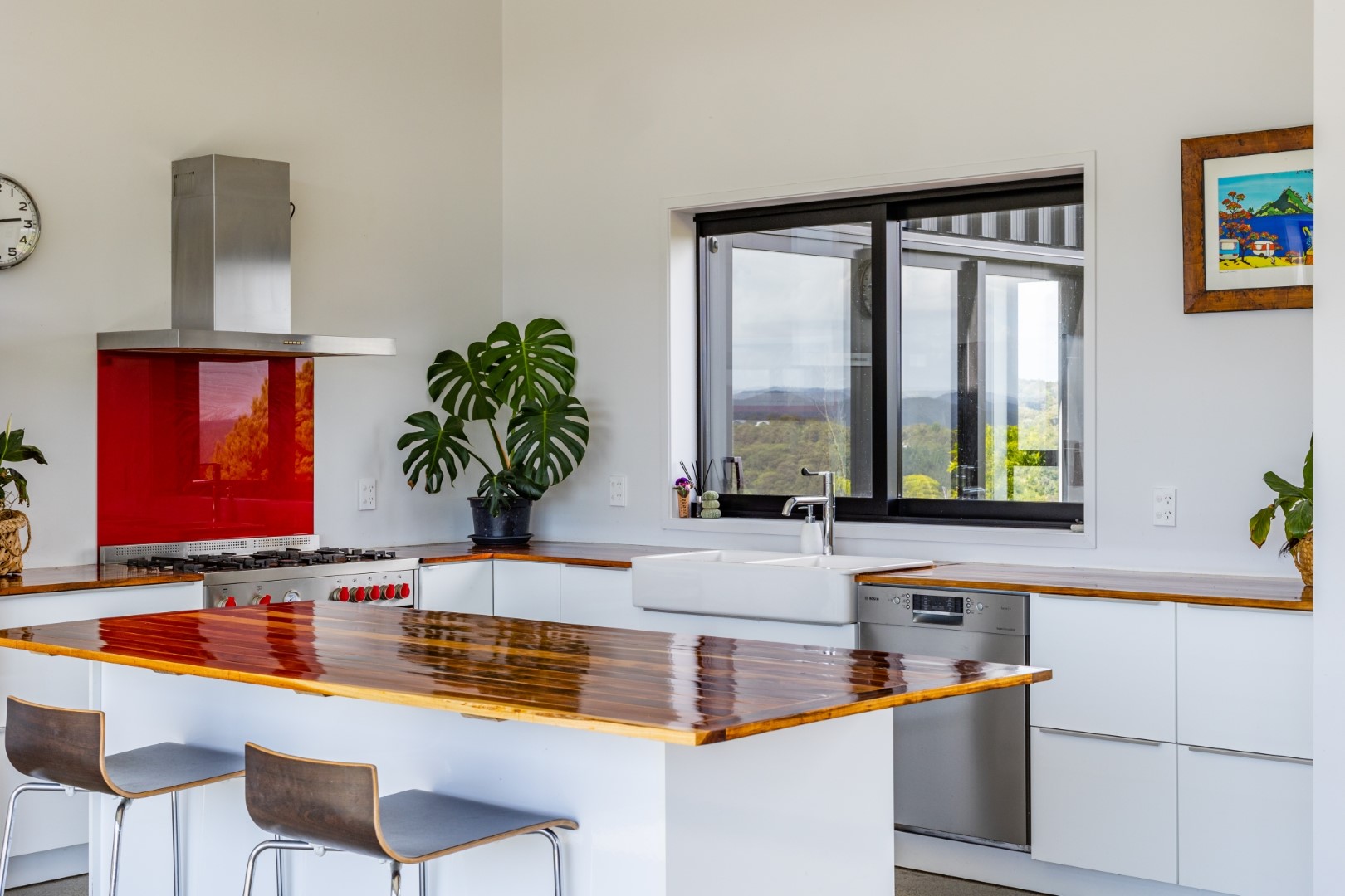 white-kitchen-red-splashback-island-layout-concrete-flooring-arcline-architecture