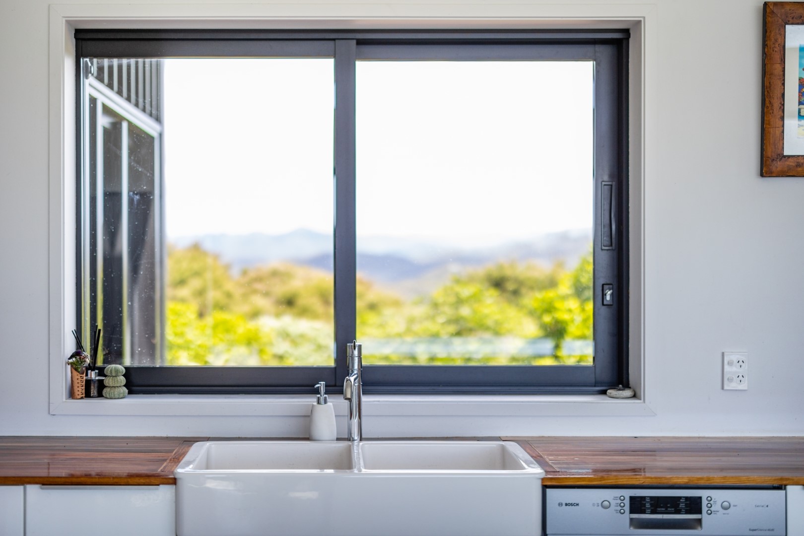 white-kitchen-wood-bench-sink-layout-paroa-bay-arcline-architecture