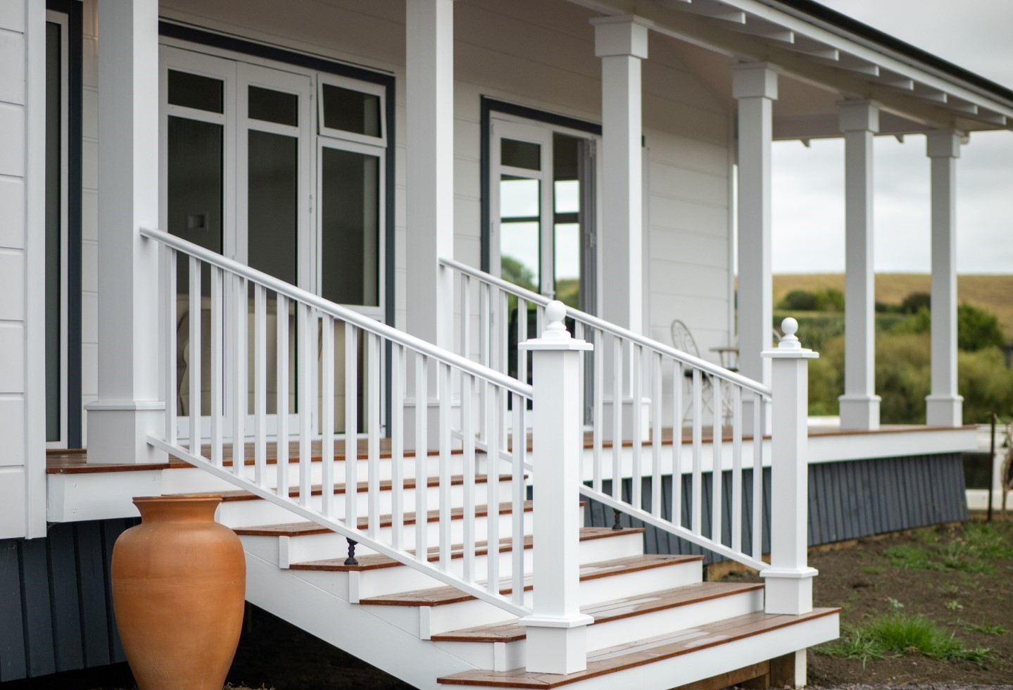 White-colonial-look-stairs-and-verandah-pillars-arcline-architecture