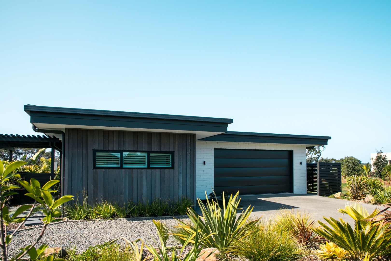 garage-door-cedar-shiplap-painted-brick-white-cladding-arcline-architecture