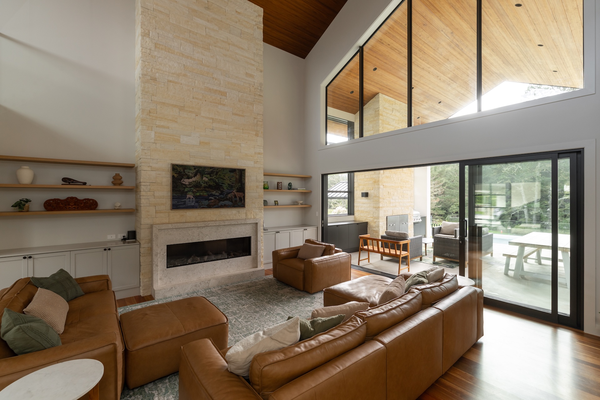 arcline-architecture-double-height-living-room-with-stone-fireplace-and-timber-ceiling