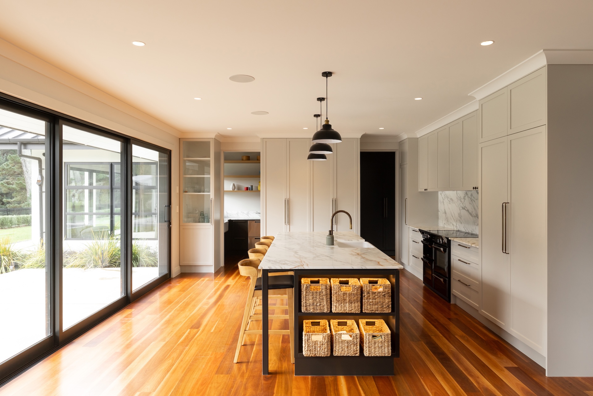 arcline-architecture-kitchen-with-marble-island-wicker-baskets-and-timber-flooring