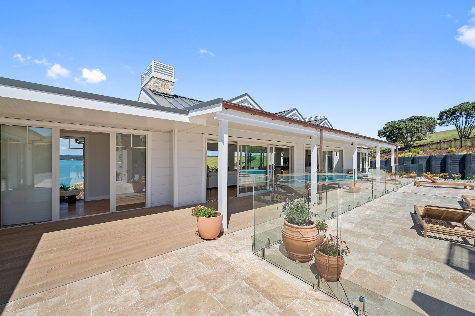 arcline-architecture-wiroa-station-residence-courtyard-veranda-millboard-deck-pool-stone-chimney