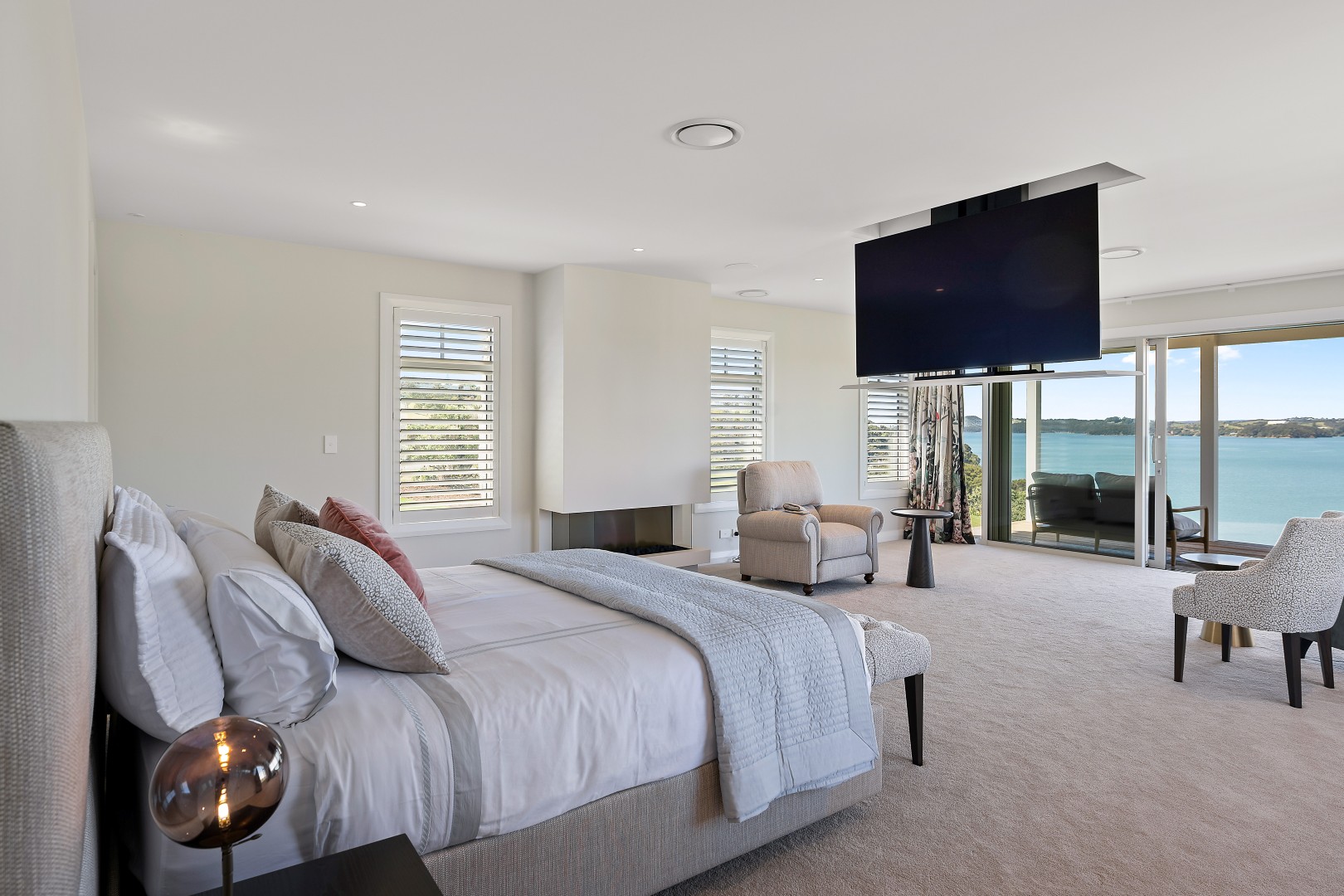 arcline-architecture-wiroa-station-residence-master-bedroom-fireplace-bay-of-islands-view
