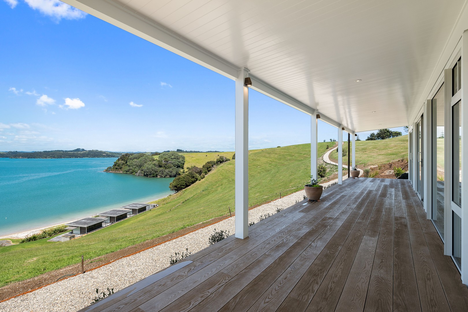 arcline-architecture-wiroa-station-residence-veranda-millboard-decking-bay-of-islands-view-columns