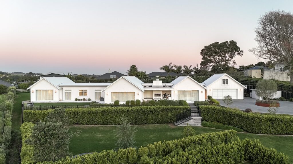 aerial-dusk-view-of-white-modern-farmhouse-home-arcline-architecture