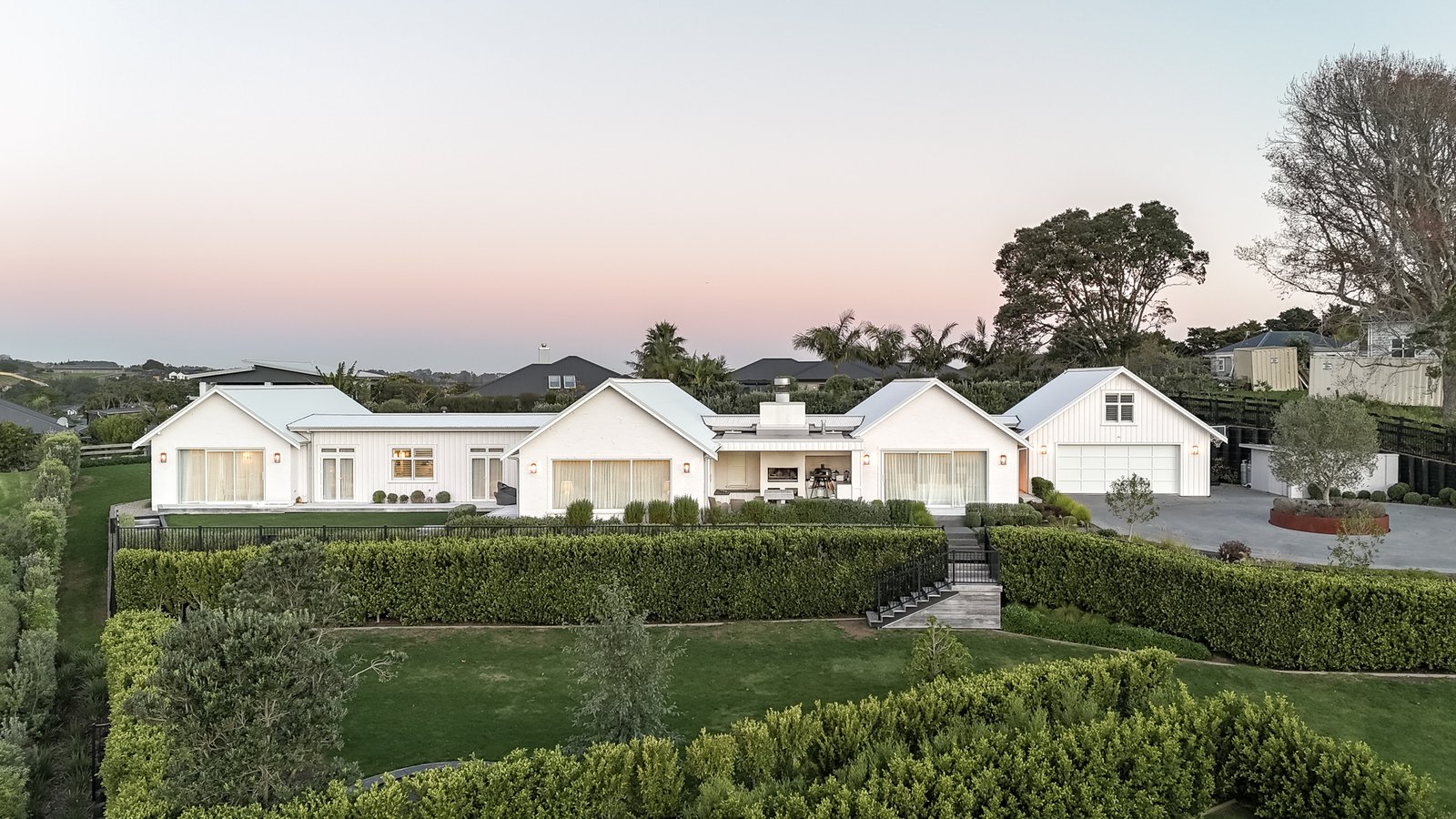 aerial-dusk-view-of-white-modern-farmhouse-home-arcline-architecture