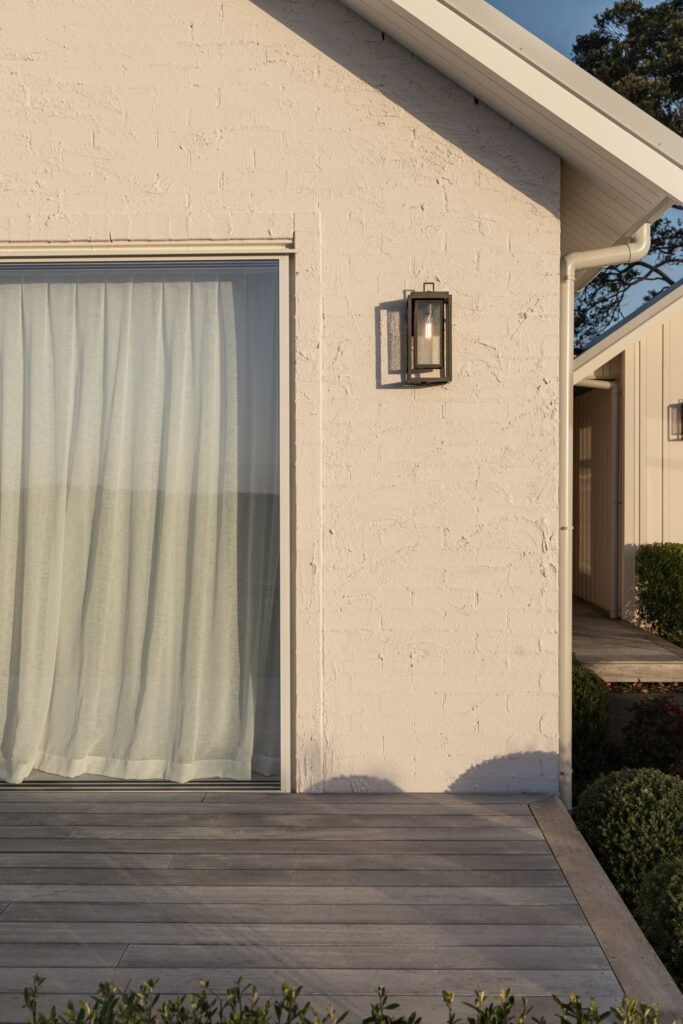 exterior-detail-sliding-door-with-sheer-curtain-and-wall-lantern-arcline-architecture