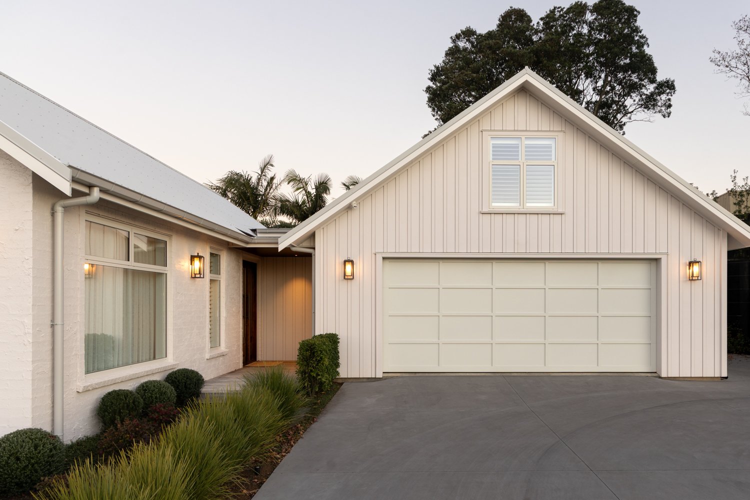 front-exterior-with-double-garage-and-gabled-roofline-at-dusk-arcline-architecture