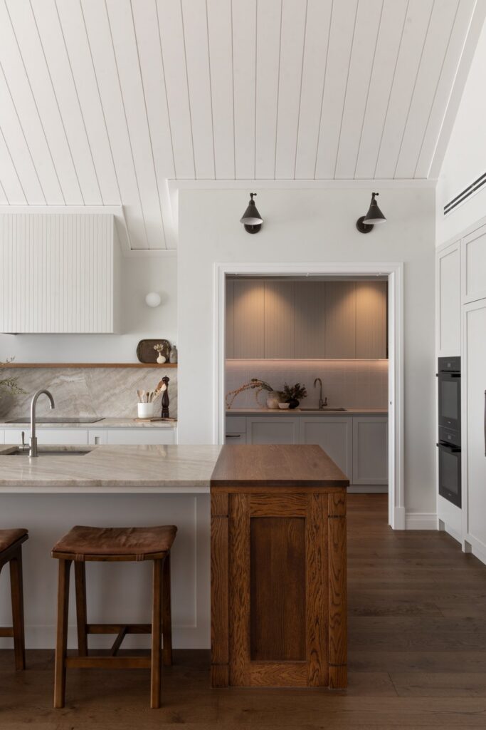 kitchen-island-view-toward-scullery-under-vaulted-shiplap-ceiling-arcline-architecture