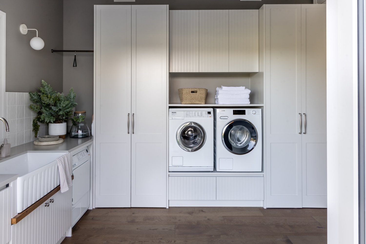 laundry-with-built-in-cabinetry-and-front-load-washers-arcline-architecture