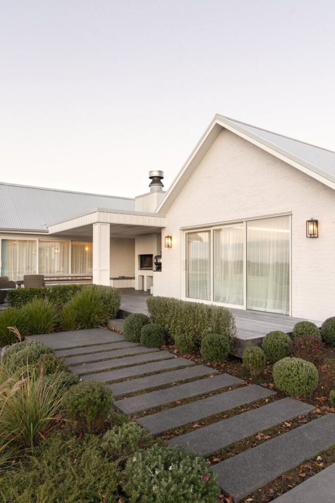 rear-exterior-with-covered-outdoor-fireplace-and-garden-path-arcline-architecture