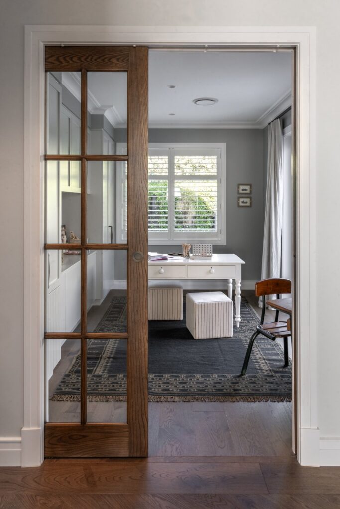 study-through-glazed-timber-pocket-door-with-desk-and-rug-arcline-architecture